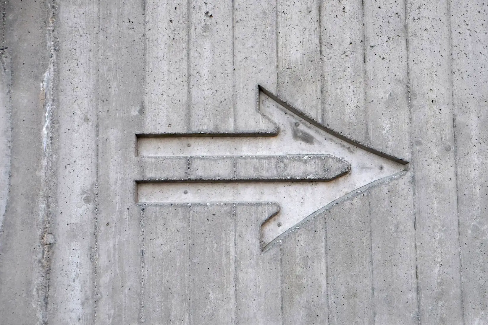 arrow cut out of concrete wall