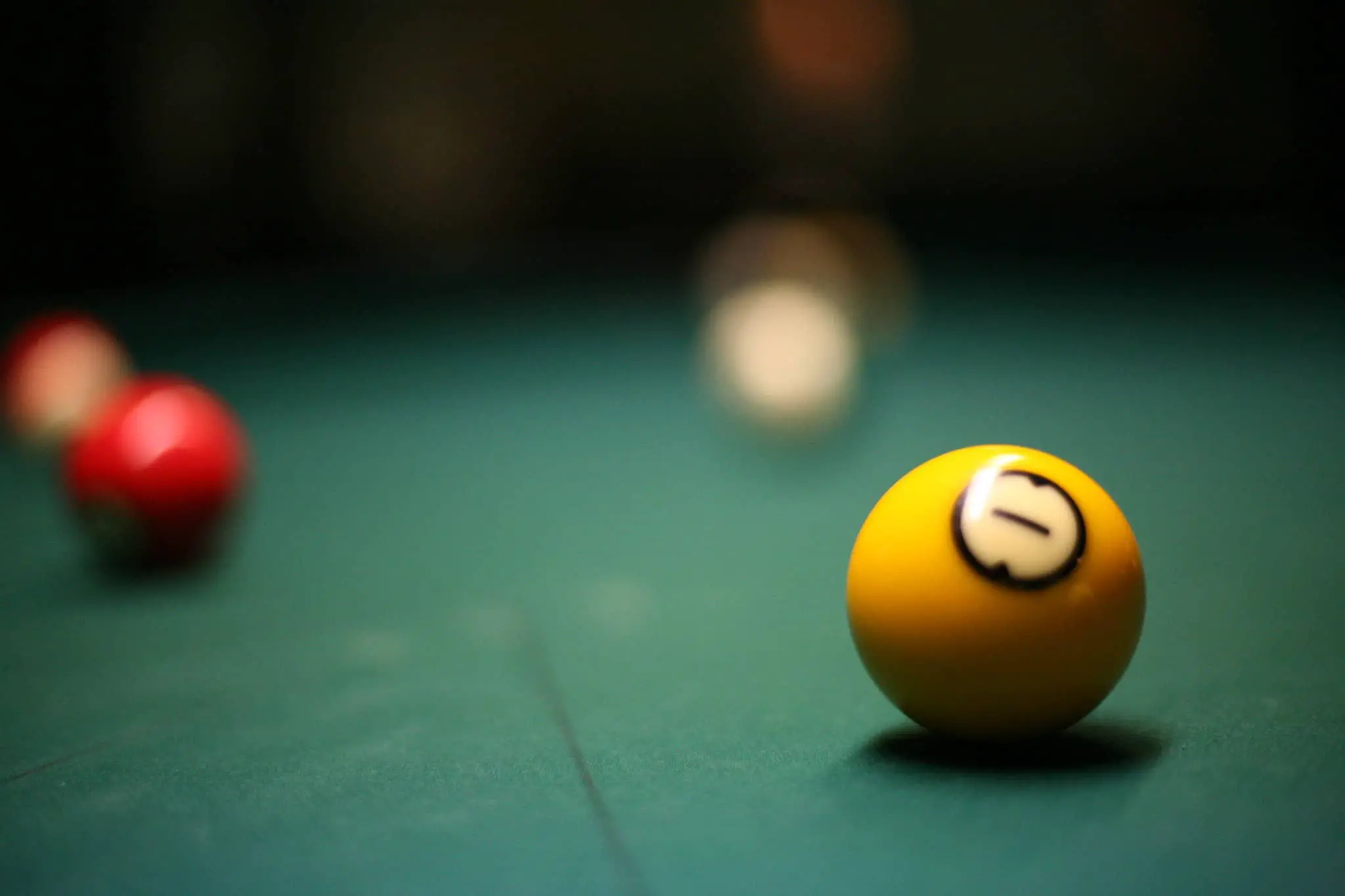 billiard ball with number one 1 on it on a billiard table