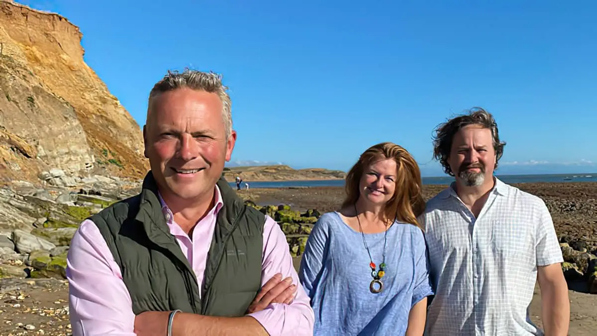 jules hudson from bbc tv with house hunting couple on the beach
