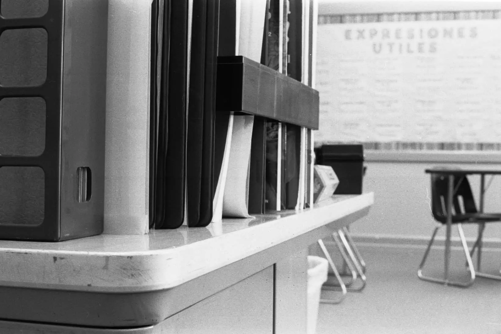 whiteboard and desks in classroom in black and white