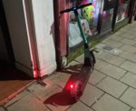 E-scooter abandoned outside a shop at night