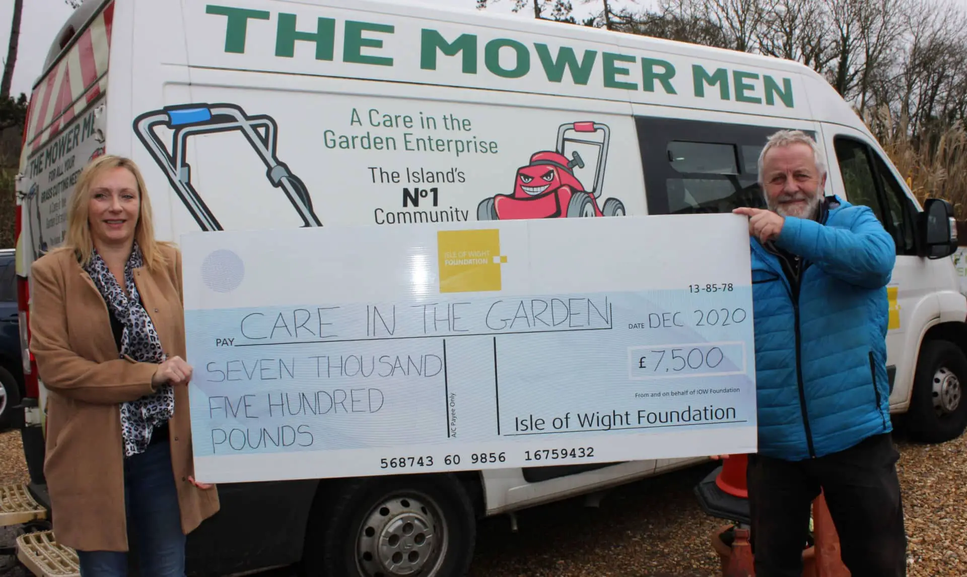 Large cheque being held by Care in the garden staff
