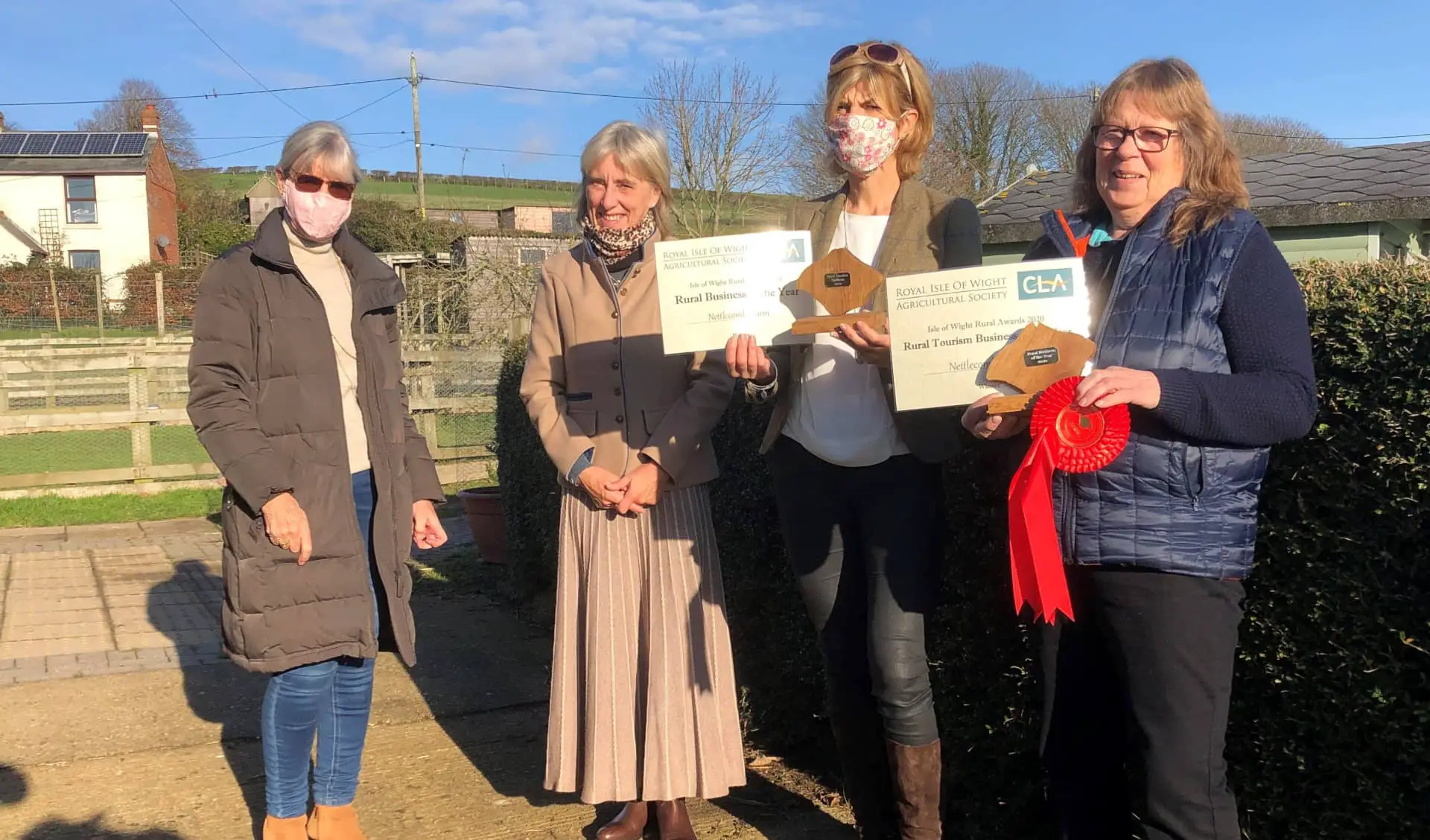 Nettlecombe Farm IOW awards 2020 - four people standing in farm yard with award certificates