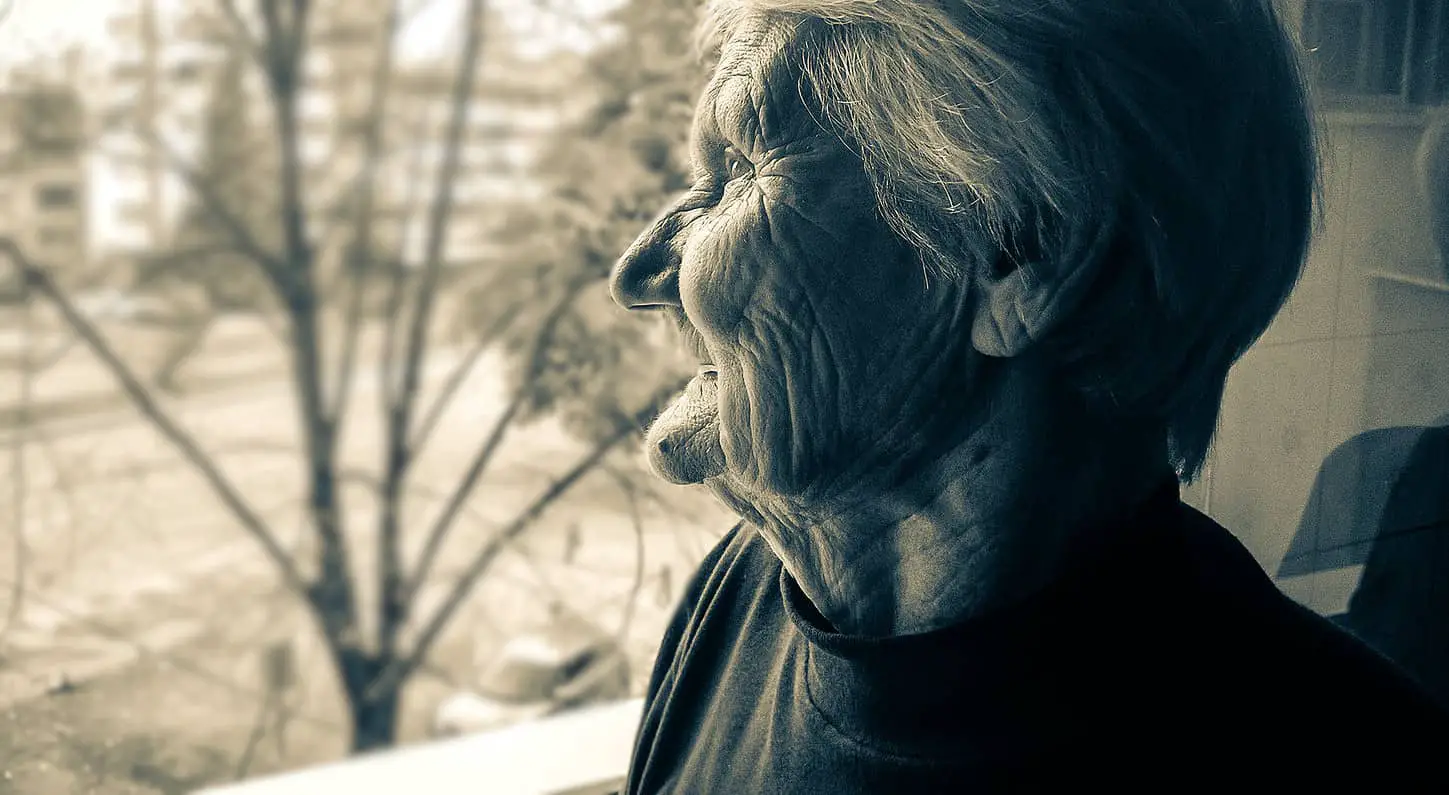 older woman looking out of the window