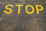 stop in yellow writing on pavement