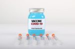 covid 19 vaccine bottle and needles
