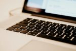 white laptop with black keyboard