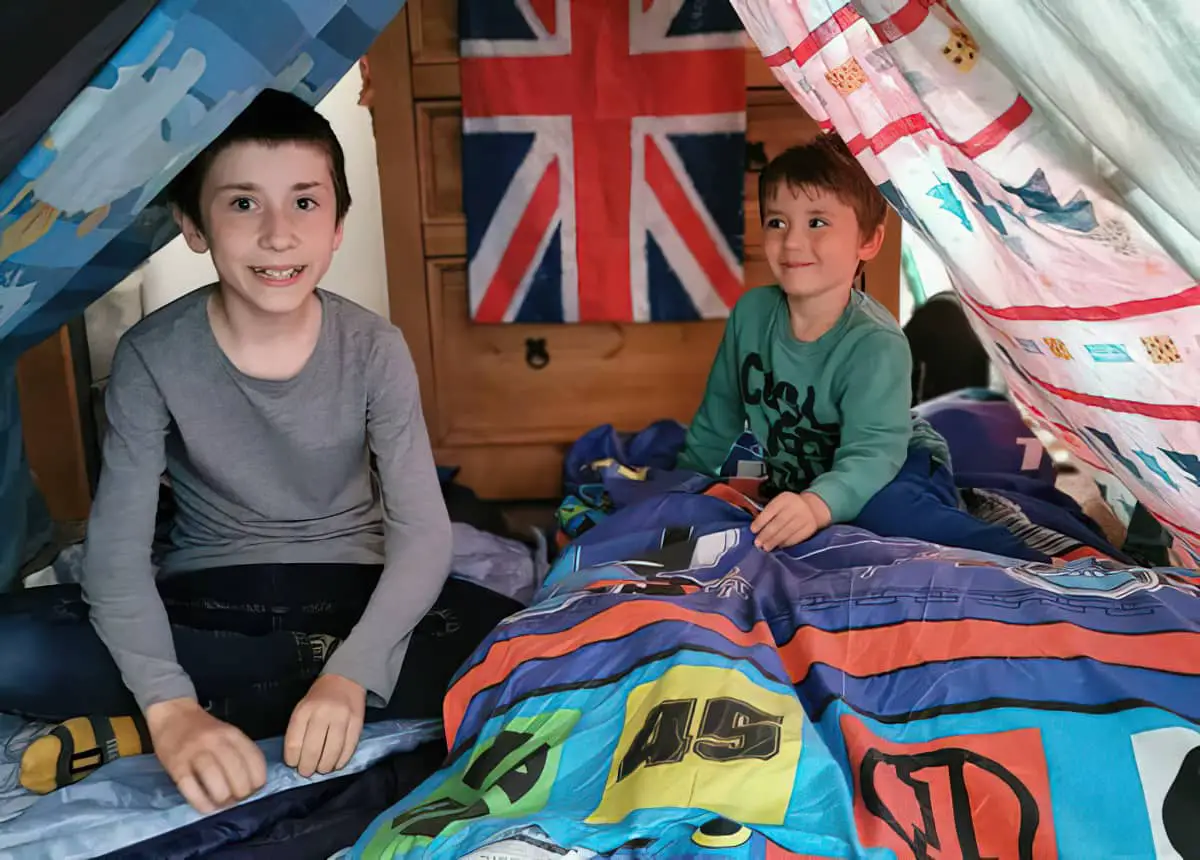 Two boys in a makeshift camp at home