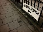 Polling station sign attached to railings