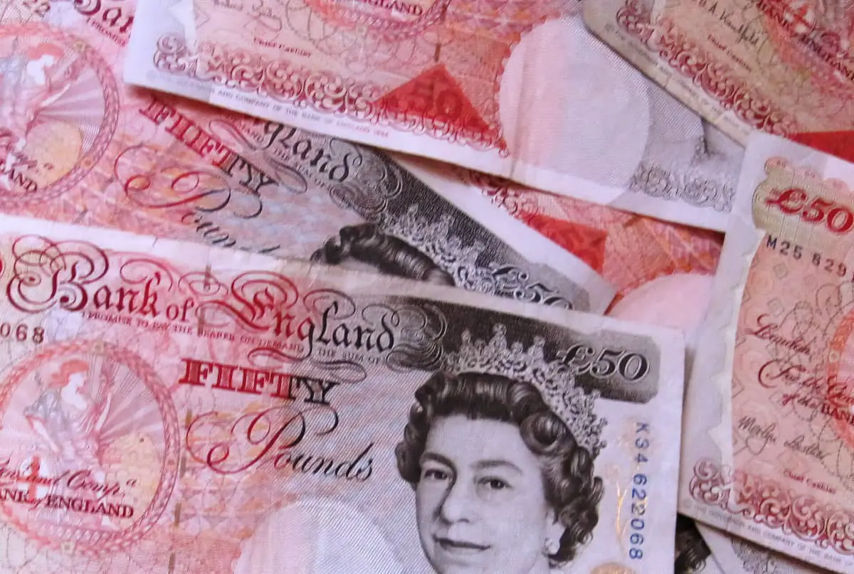 close up of fifty pound notes spread out on surface
