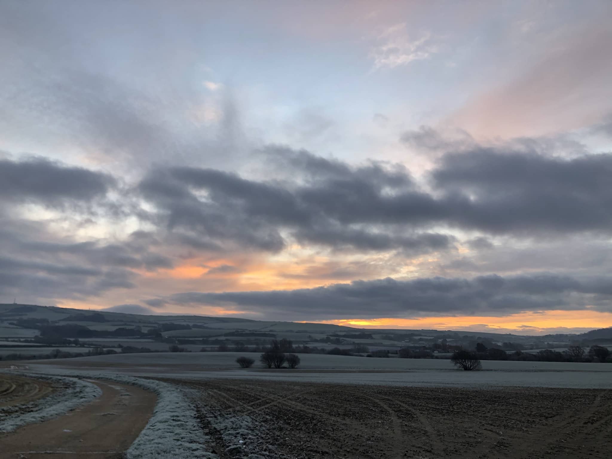 looking across the frosty farmland to the sunrise