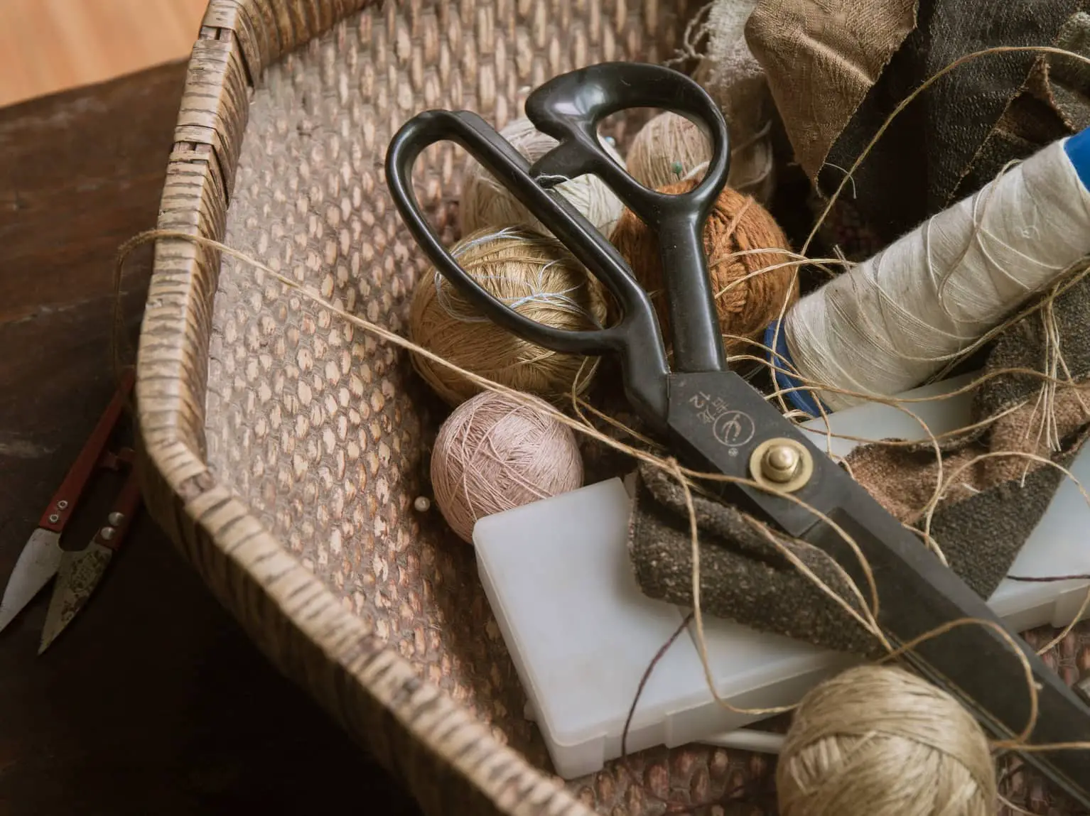 thread and scissors in basket