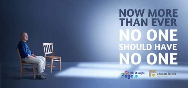 Age UK poster showing man sitting on his own with empty chair next to him
