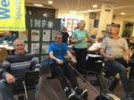 people working out on rowing machines