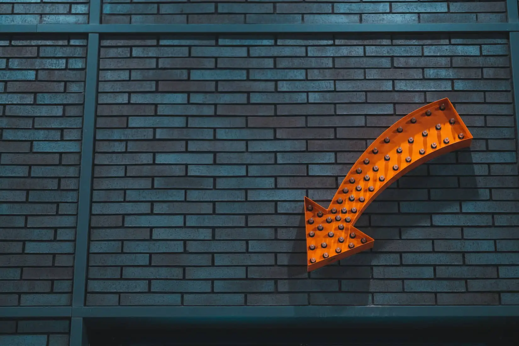 Orange arrow light on wall