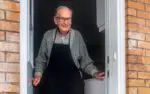 older man standing at the door