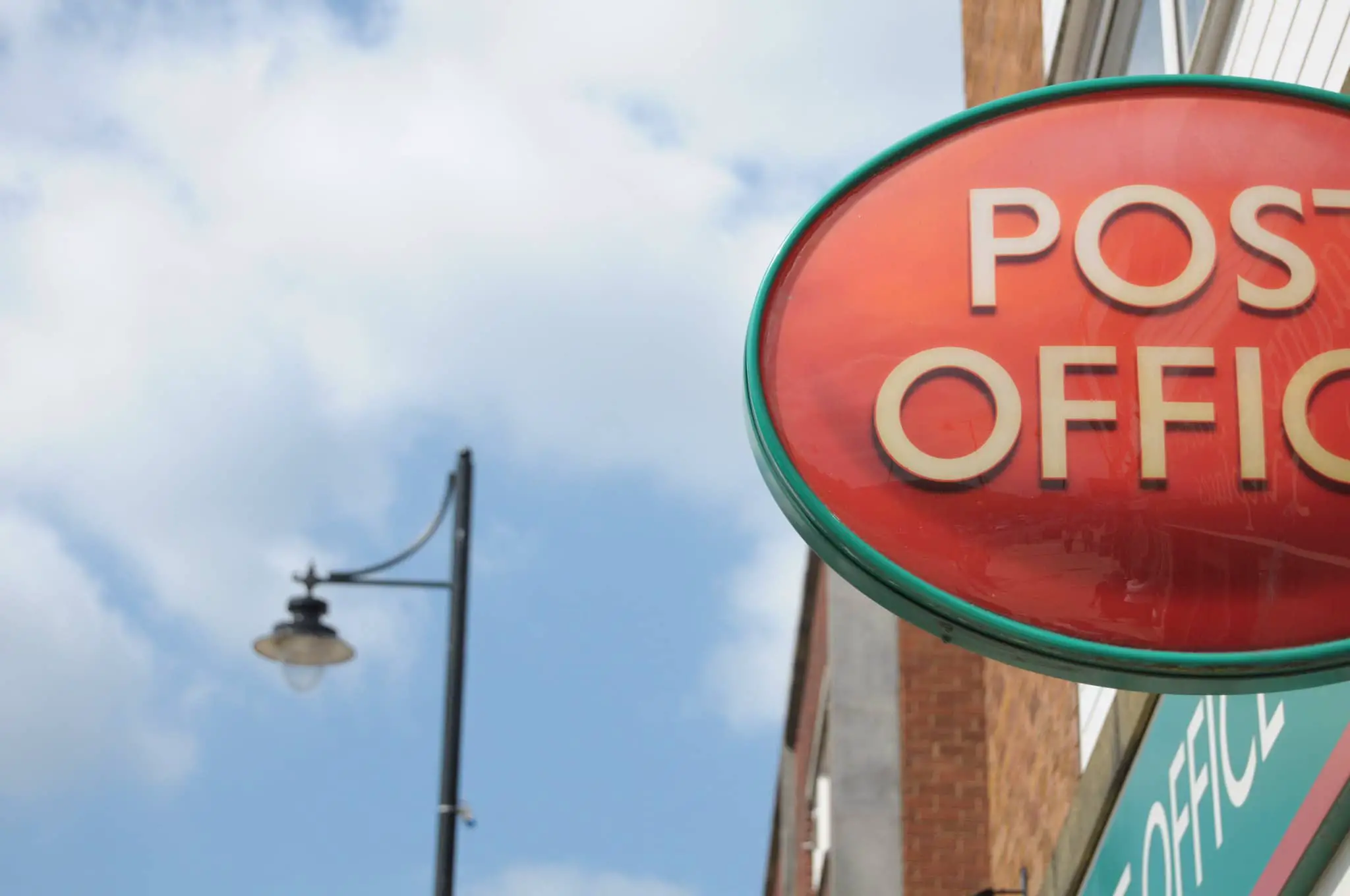 Post office sign on side of building
