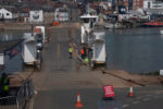 Cowes Floating Bridge suspended - workers on the bridge carrying out repairs