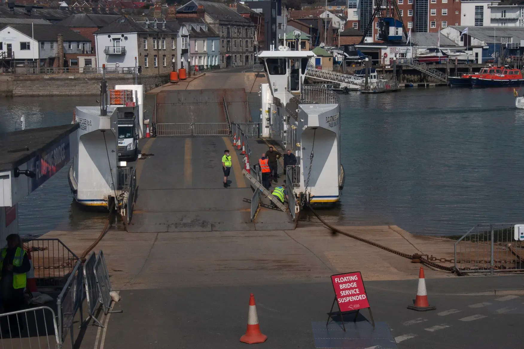 Cowes Floating Bridge suspended - workers on the bridge carrying out repairs