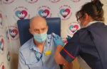 NHS staff member giving a vaccination