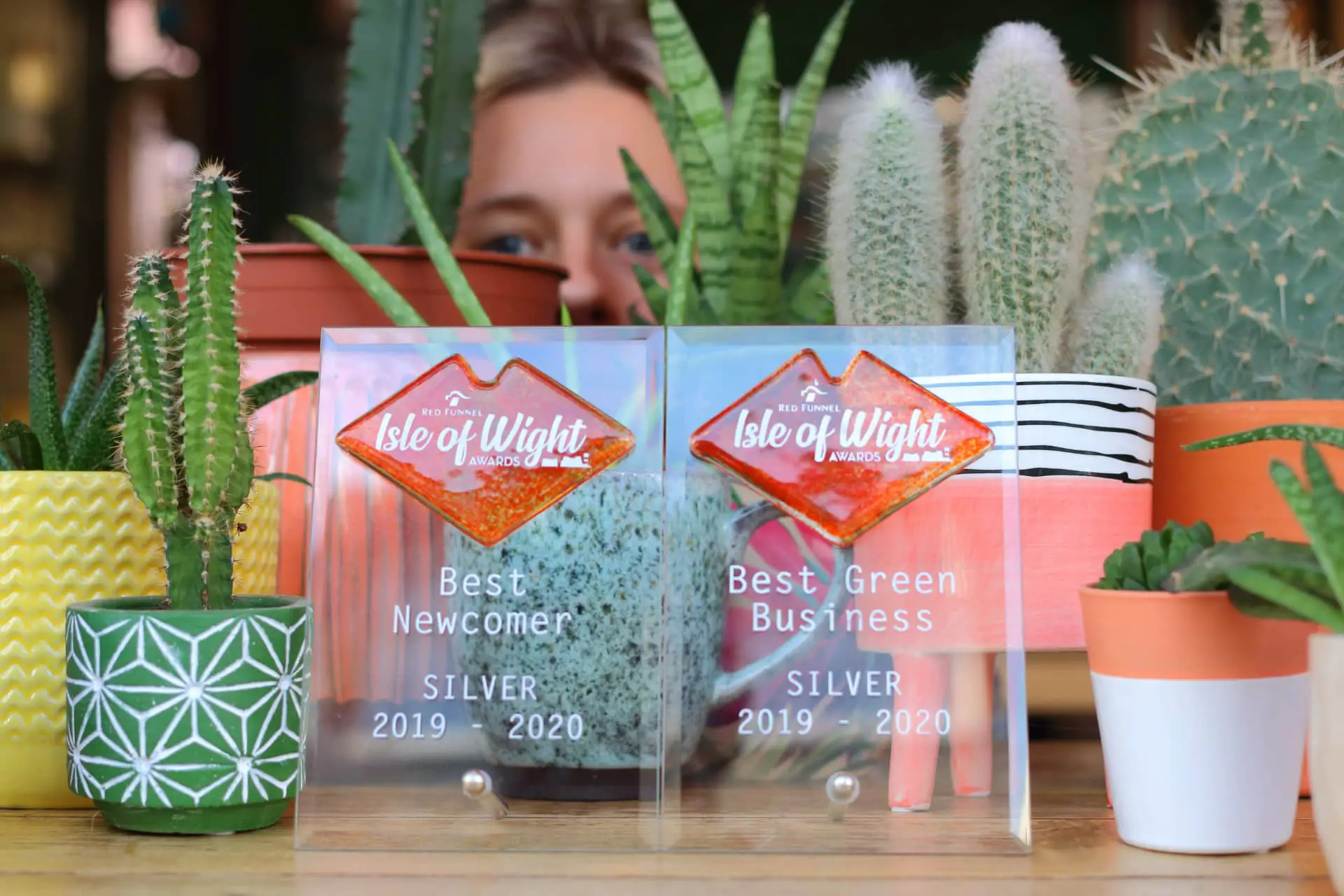 Steph peeping through plants after Peach wins Zero Waste Food Store -