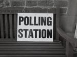 Polling station sign on a bench