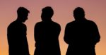 silhouettes of three men