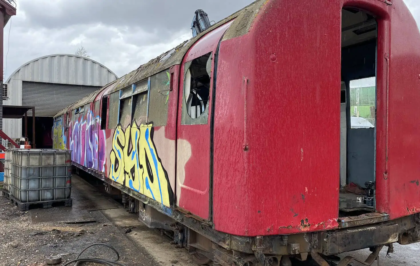 Car 225 from Class 483002 - side view with graffiti