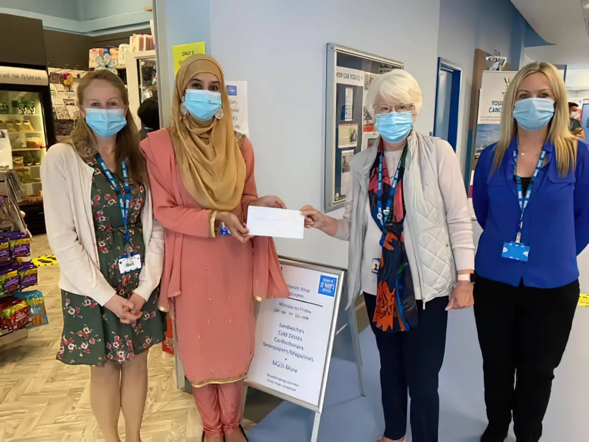 Jussna Mateen, accompanied by Pathology colleague Kerry Deacon, hands her cheque to Lesley Myland, who is joined by the Friends' Shop Manager, Lisa Brodie