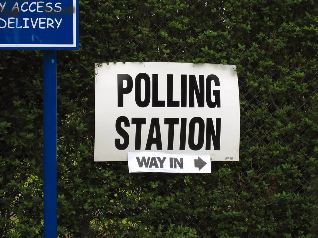Polling station sign on a bush