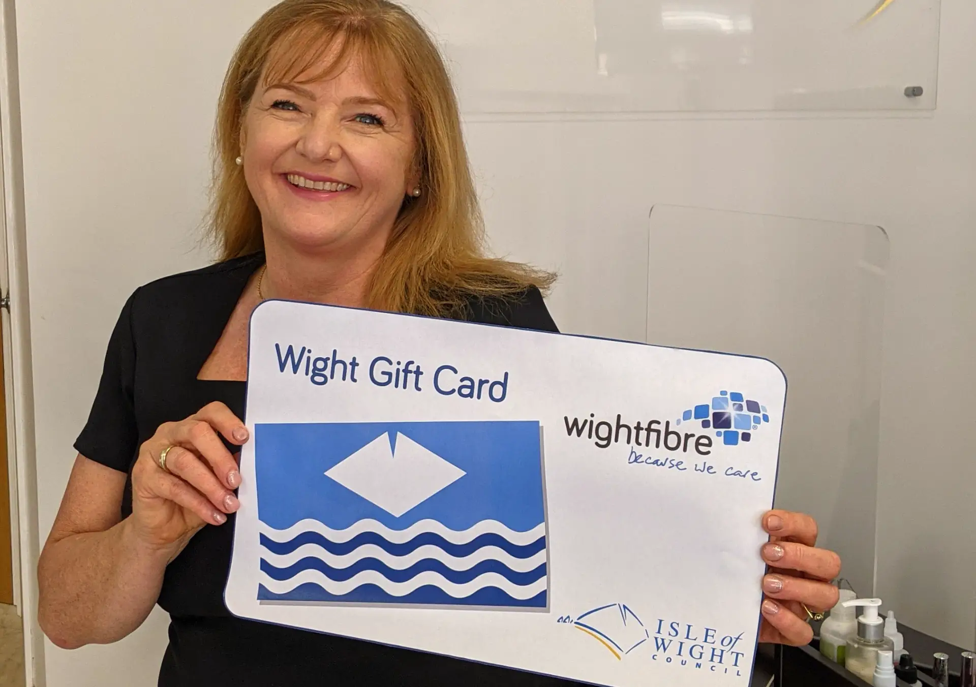 Caroline Hurley, proprietor of Becalmed Spa, Cowes, holds a giant Wight Gift Card
