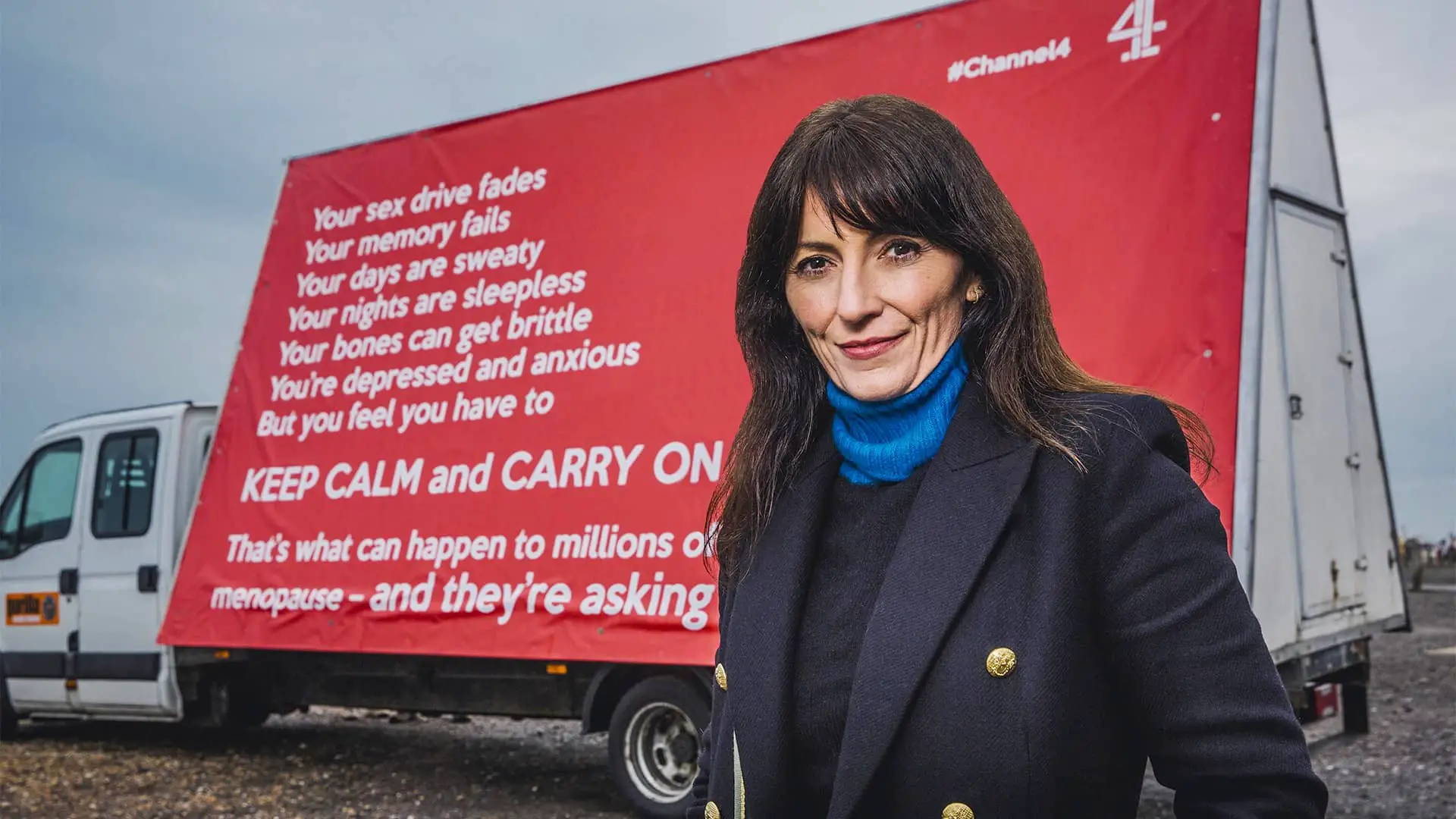 Davina McCall standing in front of an advertising board with message about the Menopause
