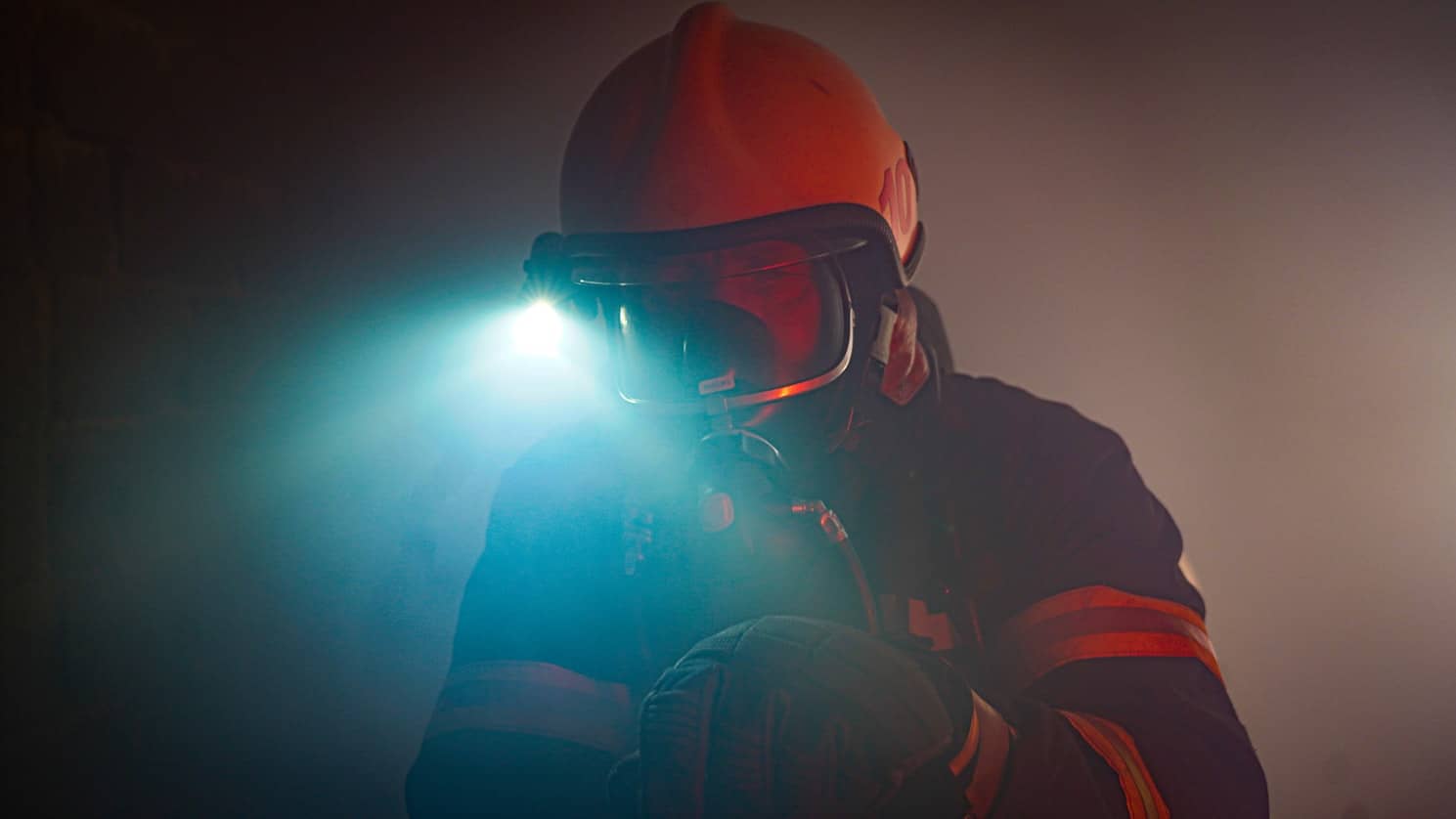 Firefighter in smoke with light