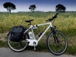 electric bike parked by a rapeseed field