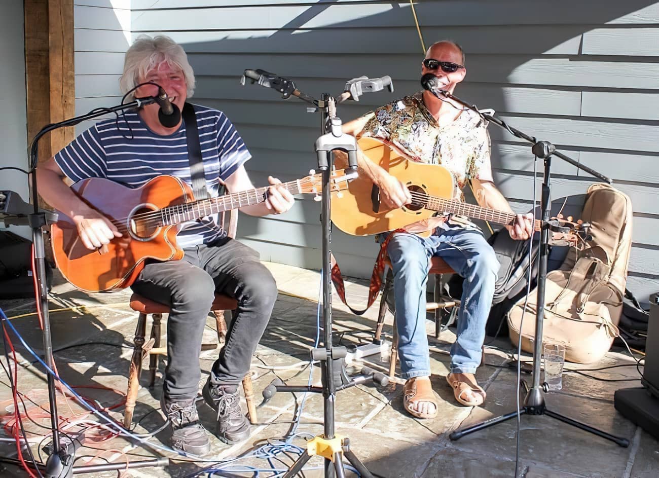 Members of Frampton Mac playing guitars