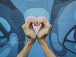 Love hand sign with graffiti background