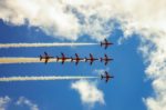 Red Arrows against a blue sky and fluffy clouds by Steven Penton