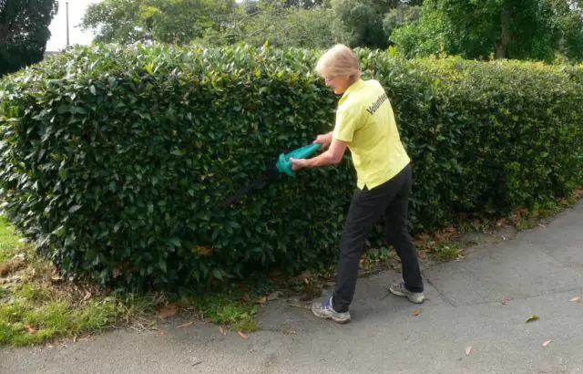 Dr Ruth Stainer with the hedge trimmer 