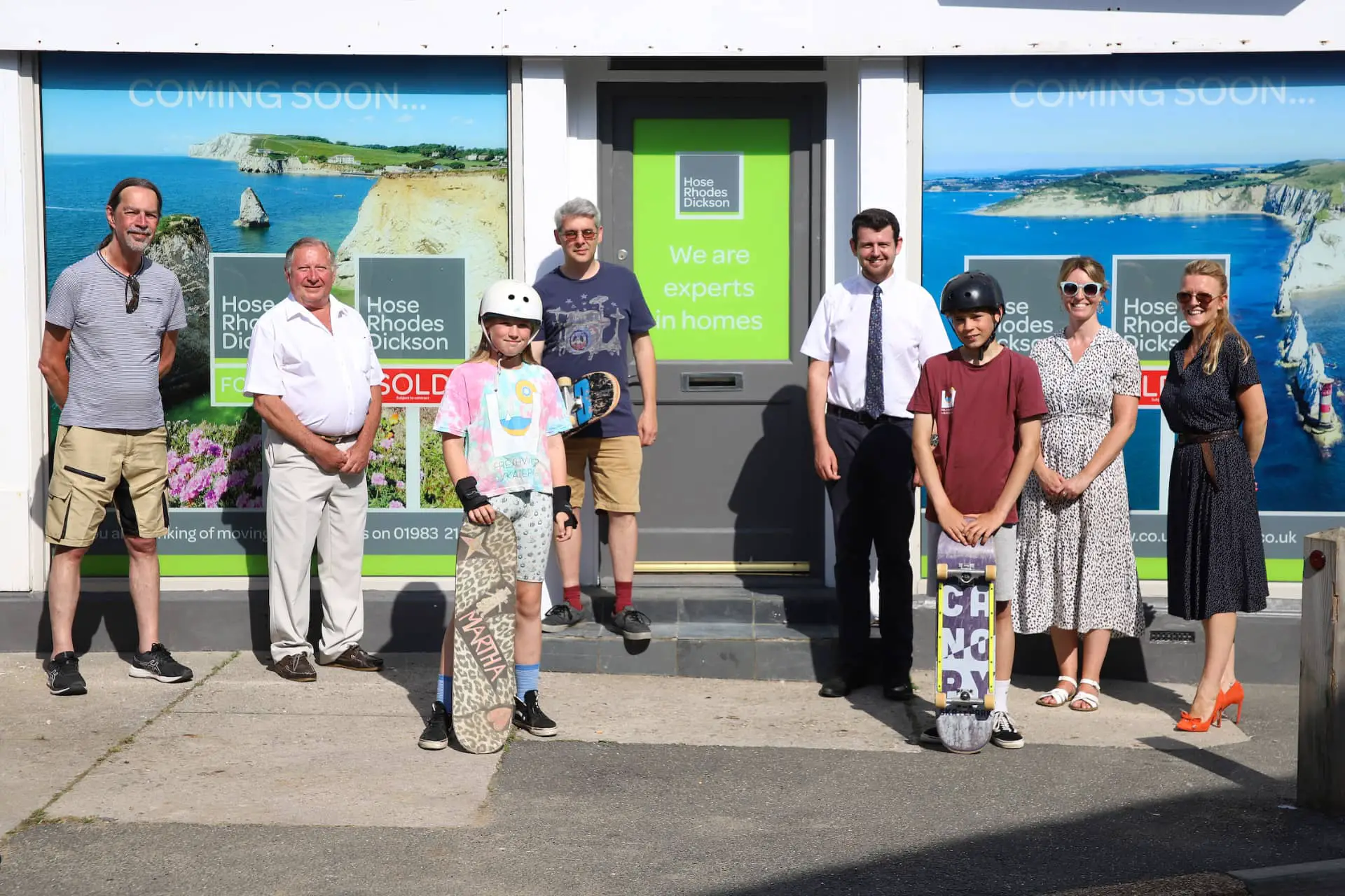 Freshwater Parish Cllr Mike Locke, Vice Chair Cllr George Cameron, Chair Cllr Daniel James, Peter Barfoot, Senior Negotiator at Hose Rhodes Dickson; Lindsay Becker Marketing Manager at Hose Rhodes Dickson and Michelle Walker, Negotiator at Hose Rhodes Dickson. Martha Eggleton 10 and Jago Tasker 12 wearing Freshwater Skatepark t-shirts Ollie in front of the new premises