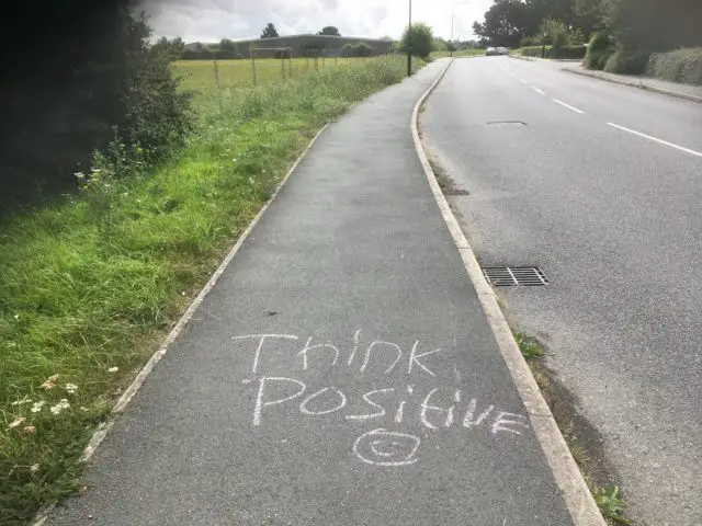 Positive messages on pavement photographed by Angela Freebrey