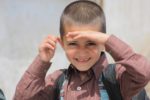 afghan boy smiling at camera