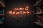 neon 'you are what you listen to' sign