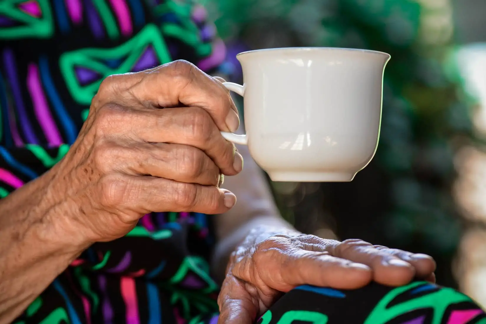 older woman holding a tea mug