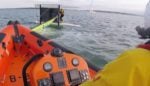 Capsized catamaran towed to safety by Cowes RNLI
