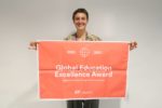Woman holding the Global Excellence Flag
