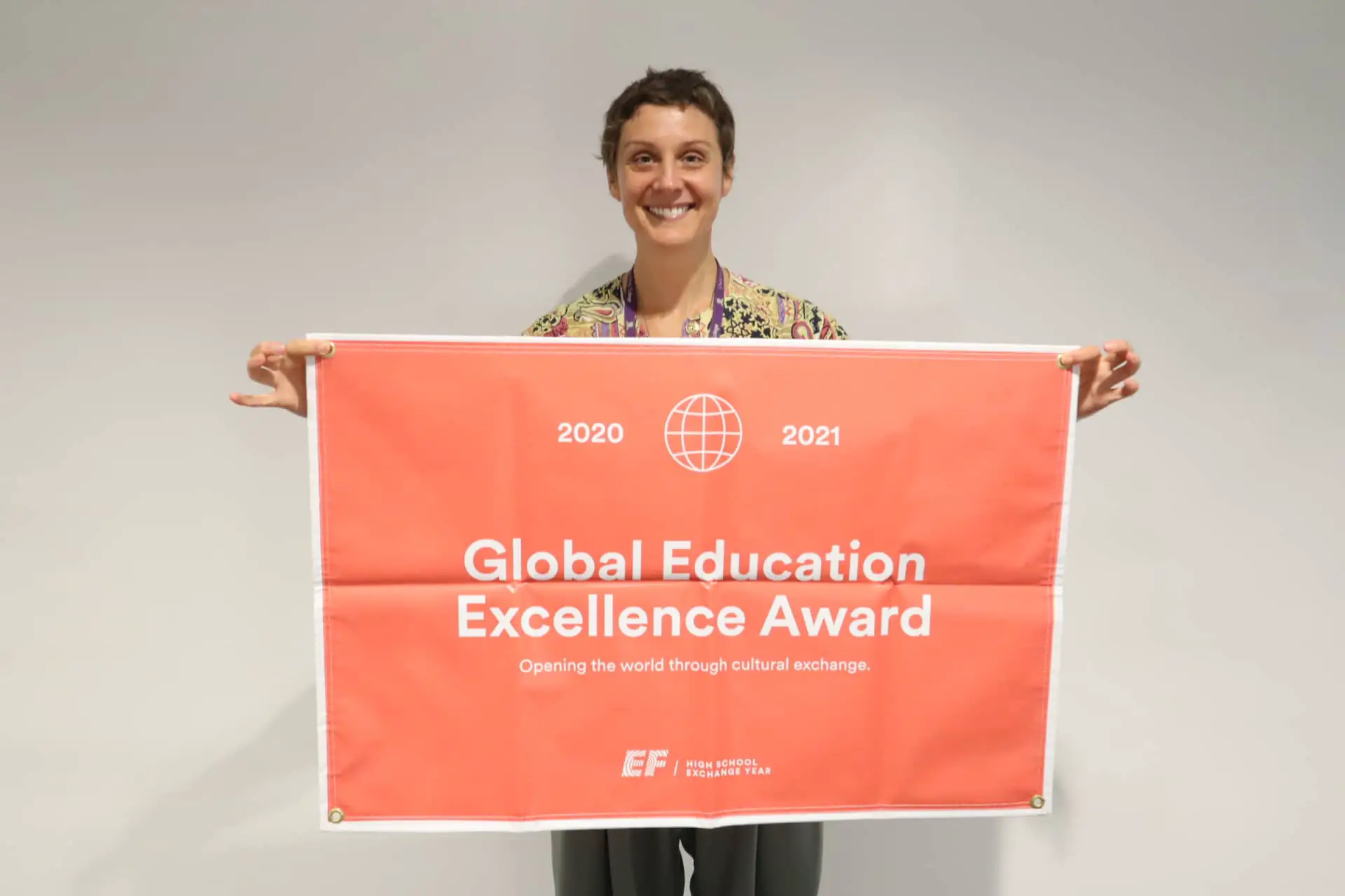 Woman holding the Global Excellence Flag