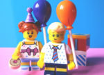 Lego woman and man celebrating with cakes and balloons