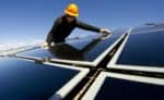 Man on roof with solar panels