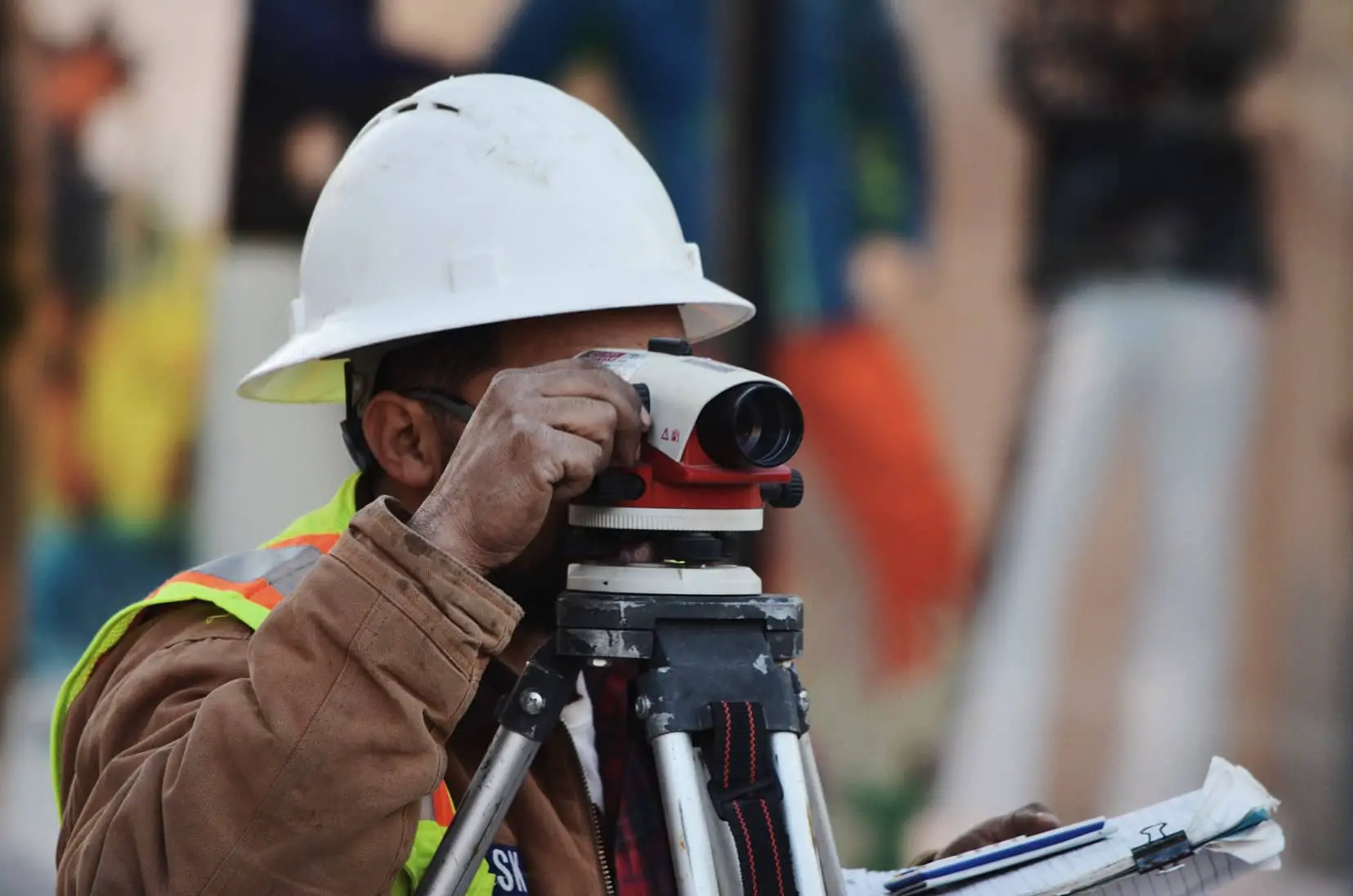 construction worker looking through sightline camera