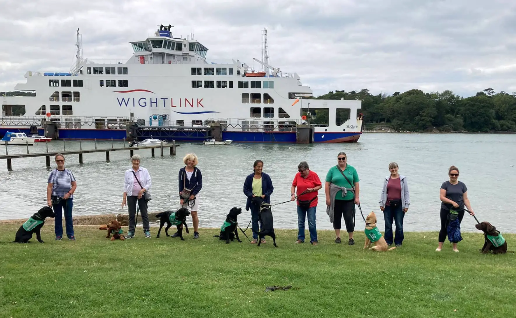 Ability dogs at Fishbourne terminal with their foster parents